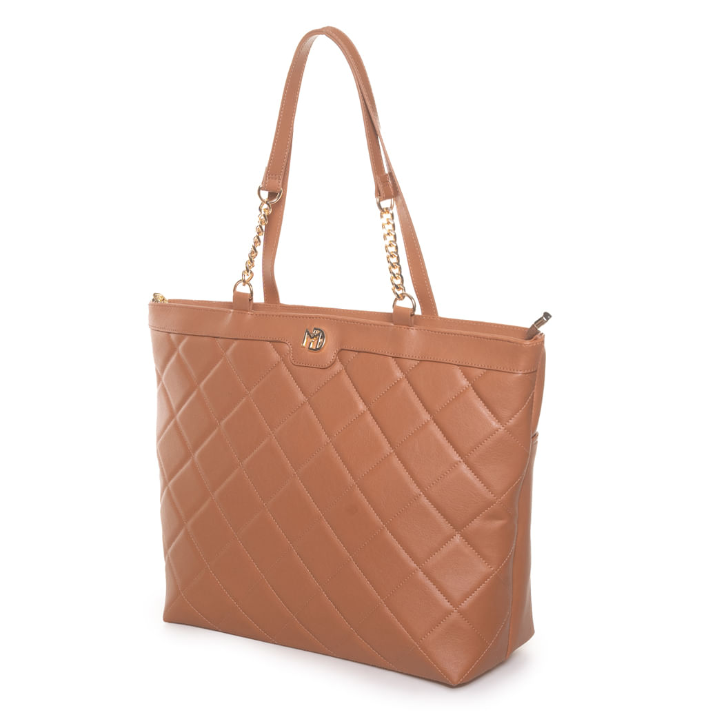 Bolsa Modare Totem bege vista lateral mostrando design trapezoidal e detalhes em corrente dourada